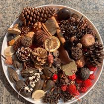 A variety of dried flowers handmade diy wood chips pine fruit leaves lemon slices scented candles Christmas wreath material
