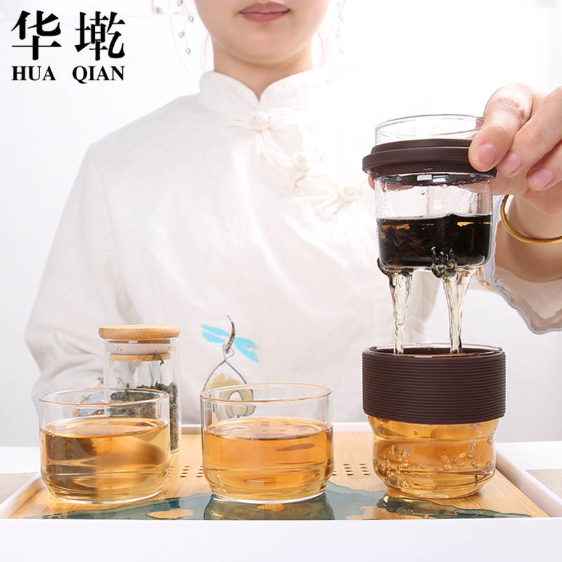 Heat resistant glass crack cup against a pot of two cups of hot ceramics glass portable travel kung fu tea set contracted