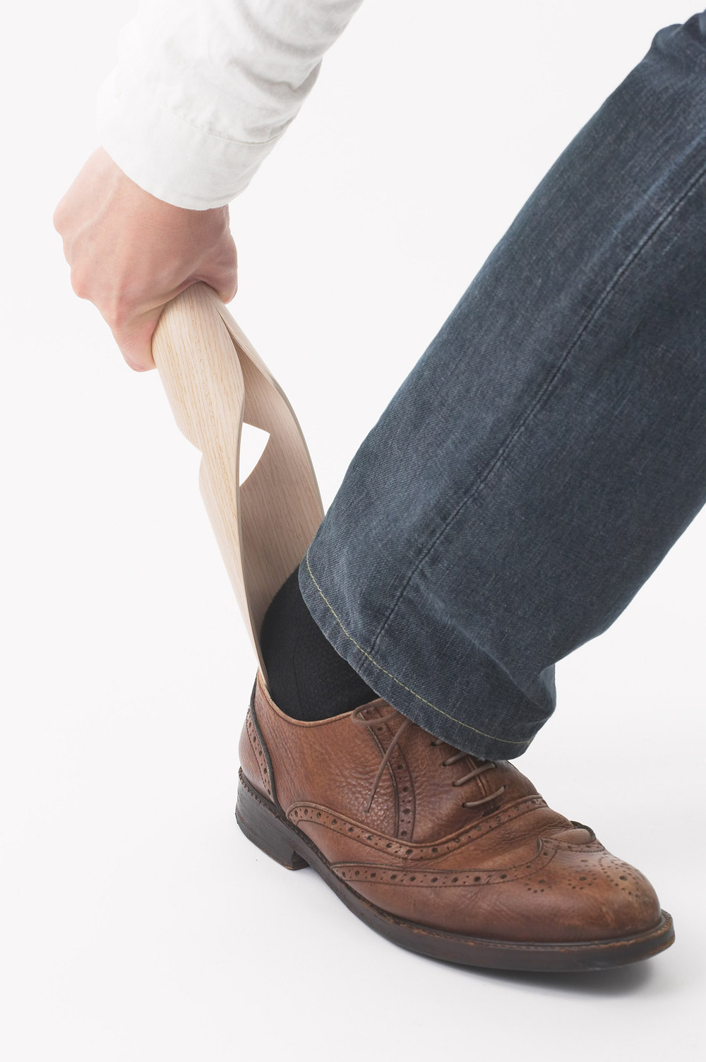 这个鞋拔使用弯曲的木头层制造的,形成了一个特别的形状,以便你在玄关