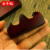 Brush pen resting on the wooden frame resting on a brush with Beacon Hill four treasures small wooden penholder brush with a bamboo pen to sign off the rack below room supplies stocked brush pen hanging pen resting