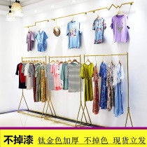 No paint clothing store Wrought iron display rack Gold floor-to-ceiling display hangers hanging on the wall wall clothes rack
