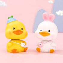 Childrens birthday with hand gift healing department office desk decoration car cute cartoon little yellow duck ornament shaking head