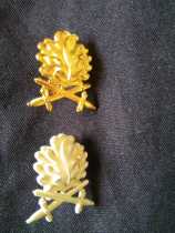 German double sword oak leaf insignia on the other.