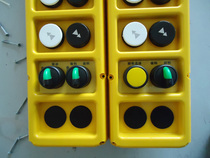 Various industrial remote controls and button boxes in Chinese and English panels