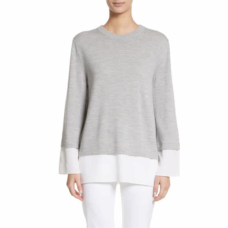 at the back and peeks from beneath the hem of this finely knit