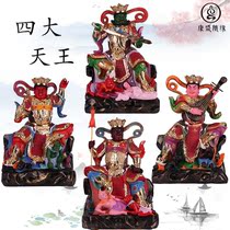 The statues of the four heavenly kings sit on the mountain and the four vajra Buddhist protectors bodhisattvas wind and rain and painted temple ornaments