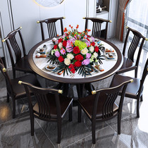 In the middle of the big round table in the hotel there are artificial flowers plastic flowers silk flowers fake flowers decorative flowers table flowers electric turntable flowers