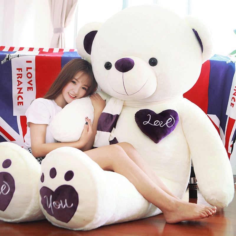 girl cuddling with giant teddy bear