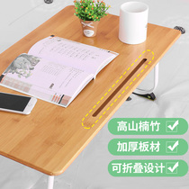 A small table on the bed A small table on the bed A small table on the bed A folding lazy person on the bed in the bedroom of a college student