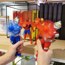 Autman fan holds a rocking mini male and female child sand sculpture toy Superman pranks a Spider-Man couple presents