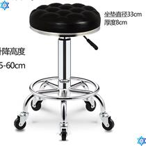 The barber works on a high stool for hair cutting and