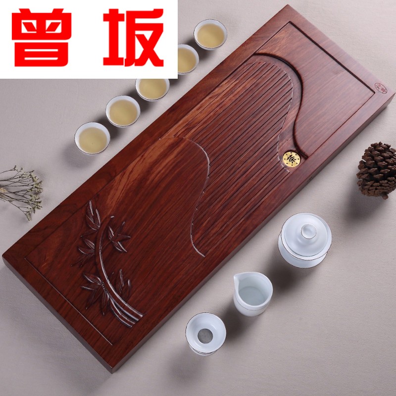 Once sitting on the whole long flat mahogany wood hua limu tea tray was large Brazilian safflower pear log tea table