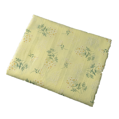 乳白花簇提花条服装布料