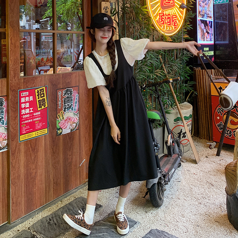 Two piece black strap skirt short sleeve white top