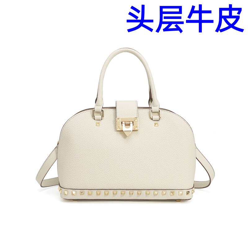 铆钉贝壳包女2026新款真皮时尚手提斜跨单肩轻奢小众高级感轻奢包