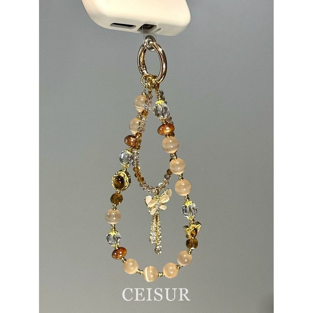 进口美拉德猫眼虎眼石水晶蝴蝶流苏手机链精致百搭包挂件ccd相机