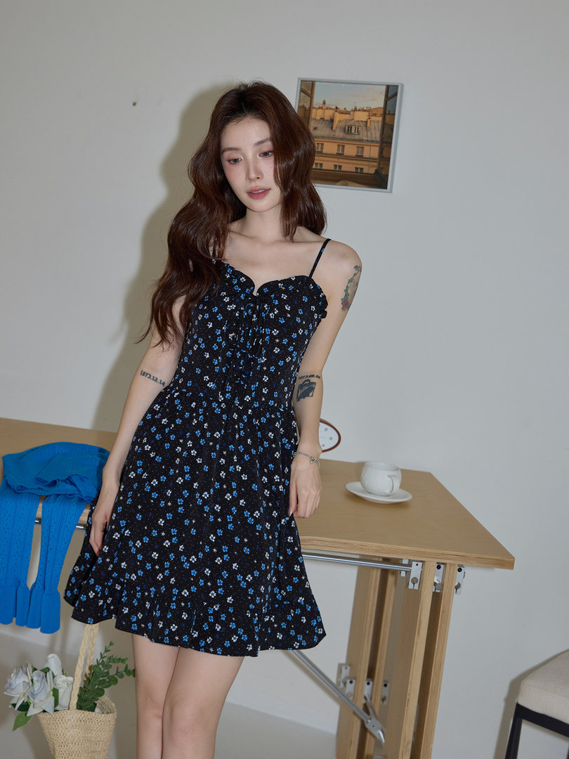 Model wearing a black floral spaghetti-strap mini dress