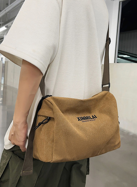 单肩包男生日系休闲帆布包2026秋季简约通勤斜挎包潮牌学生邮差包