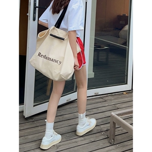 十一石休闲百搭通勤帆布包女大容量单肩包手提拖特包学生拎书袋