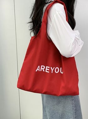 新款小众时尚字母帆布包2024单肩大容量红色托特通勤包休闲慵懒风