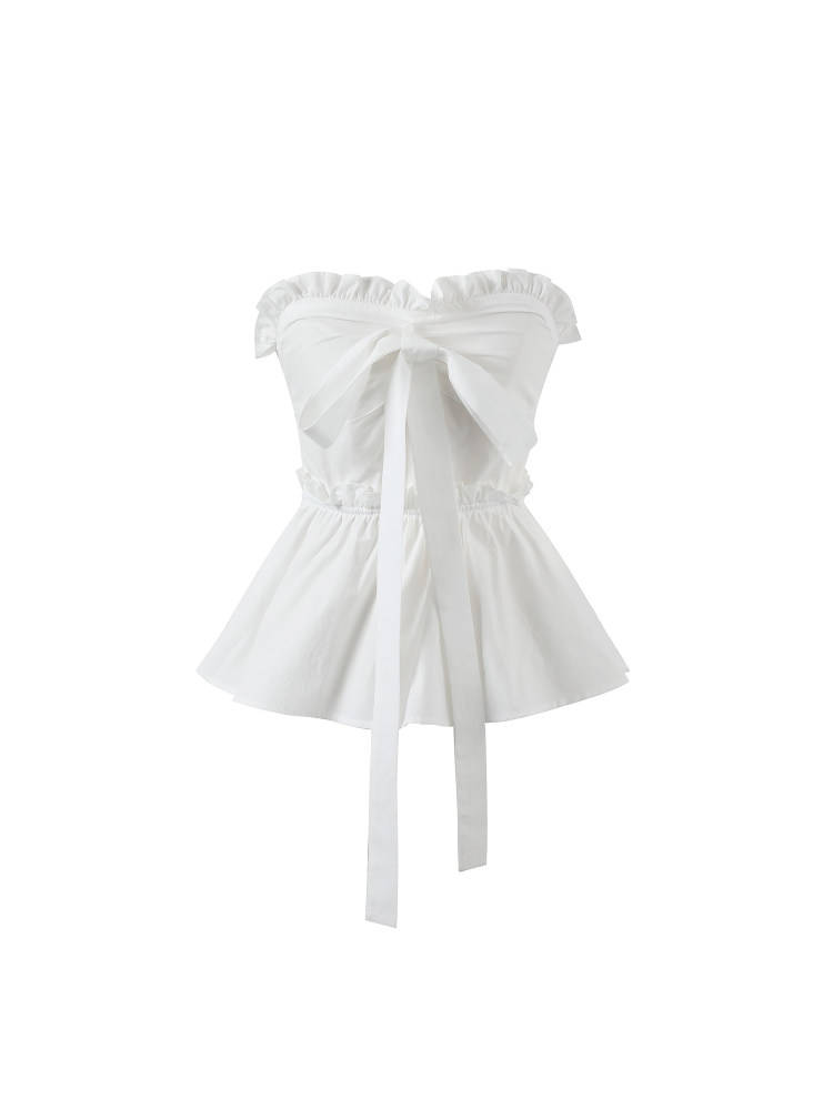 White strapless peplum top with a bow detail on a white background