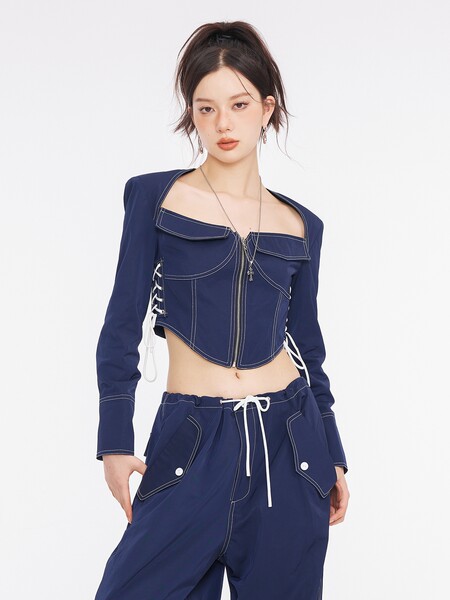 Model wearing a navy blue cropped long-sleeve top and matching pants set