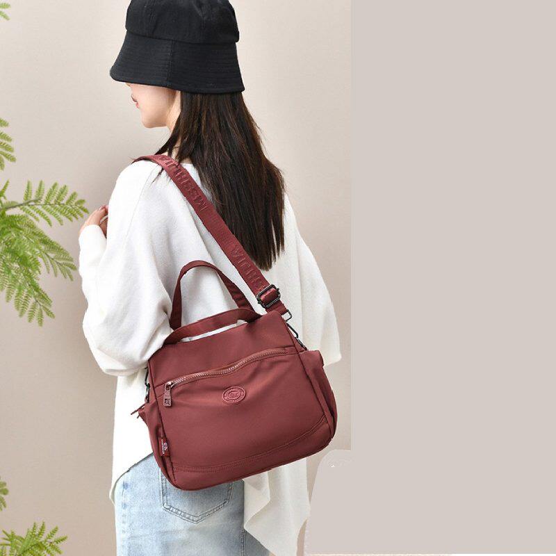 2026防泼水布料双侧水杯伞插位女式手提单肩斜挎9.7寸平板休闲包