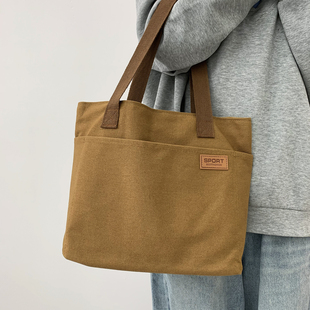 日系帆布托特包2025秋新款男女大容量通勤大口袋手提包