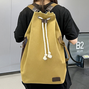 百搭帆布书包女简约复古抽绳休闲水桶包高中生男大学生旅行双肩包