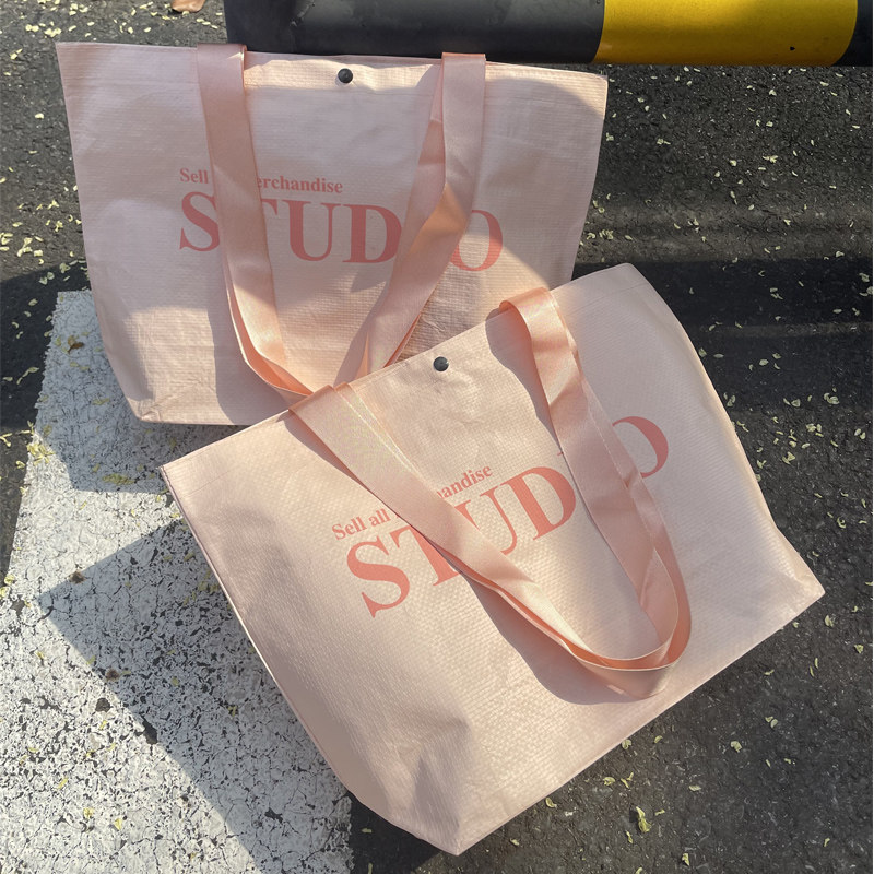 高档服装店手提袋暗扣粉色编织袋图片
