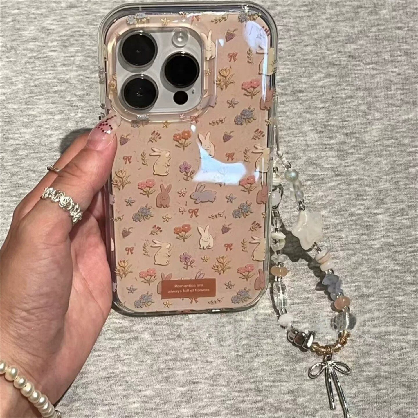适用苹果系列iPhone17新款手机壳16promax14promax奶茶色清新花花兔子15promax/13pro半包大孔防摔网红保护套