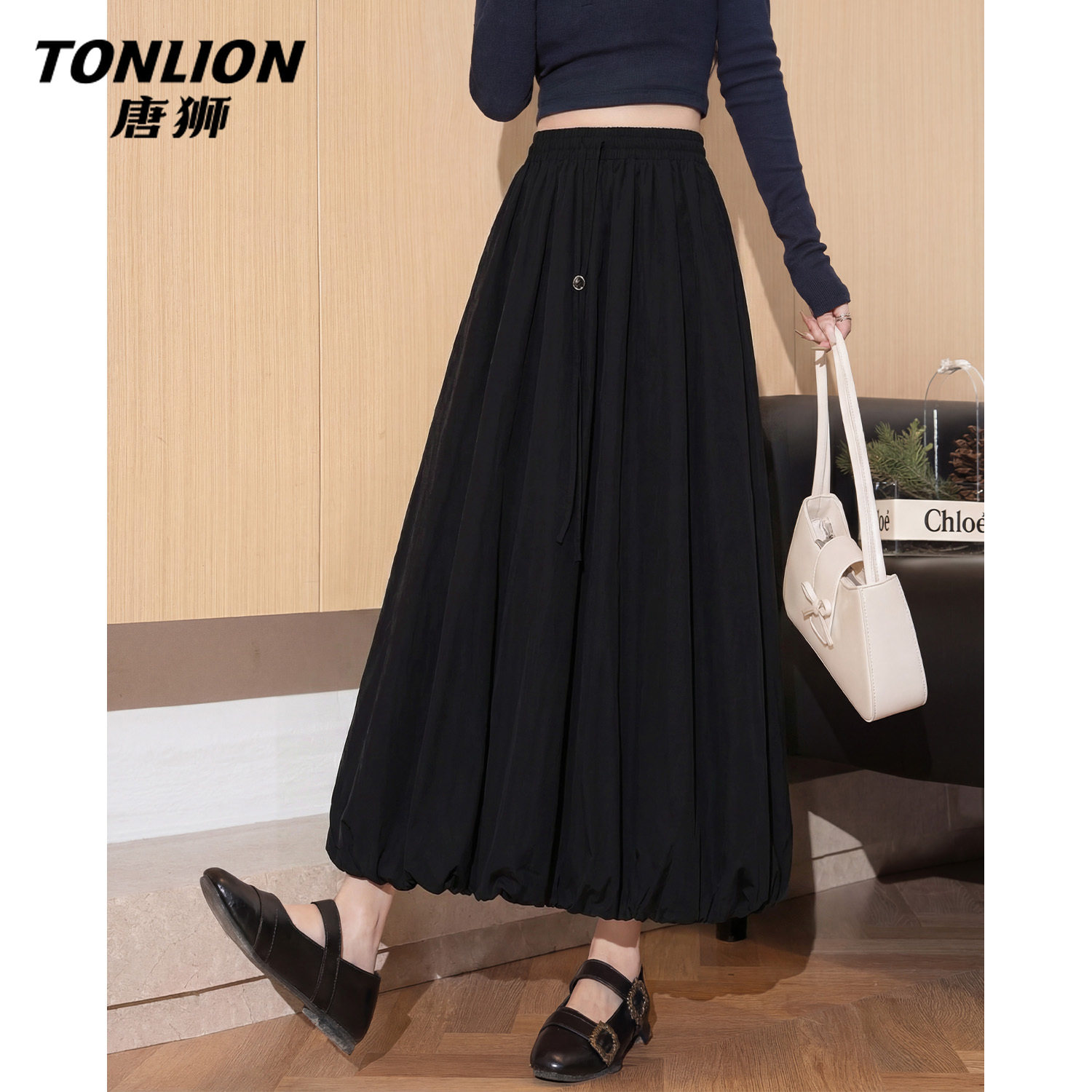 唐狮官方黑色花苞半身长裙女2026新款春秋款高腰a字百搭中长裙V