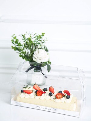 Double sided plastic film covered transparent cake roll pack