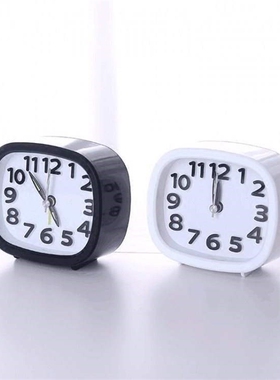 Digital alarm clock at the head of a bed is