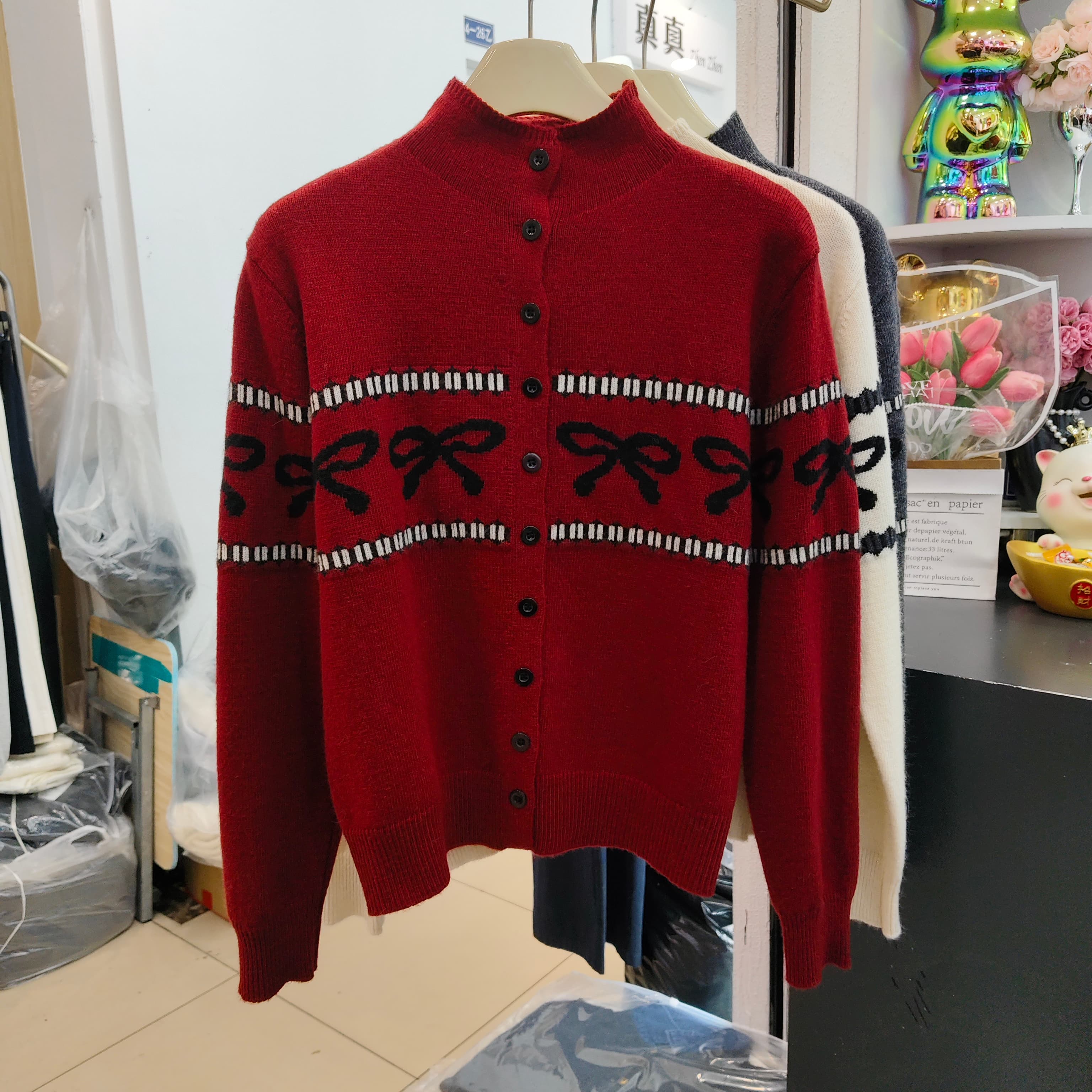 蝴蝶结提花浣熊绒针织开衫女