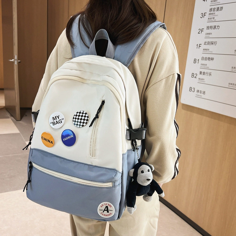 学生书包2023新款竖拉链款徽章大容量初高中生双肩包