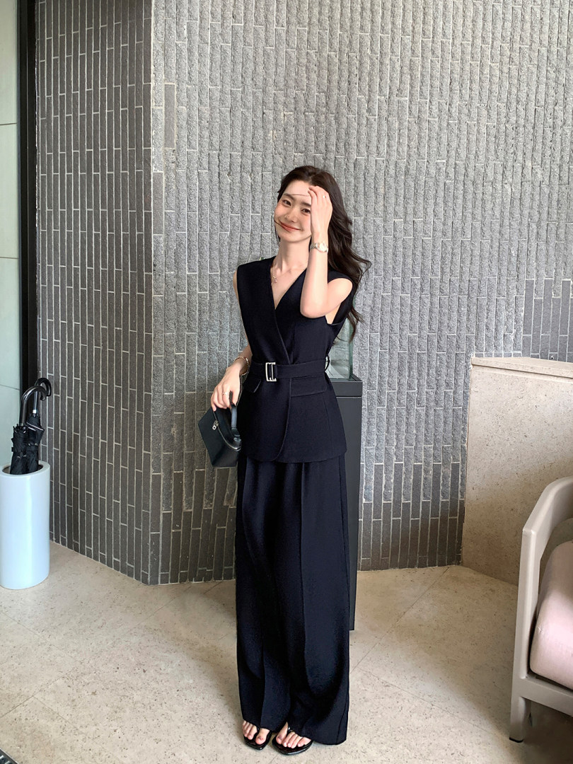 Black sleeveless belted wide-leg jumpsuit worn by a model