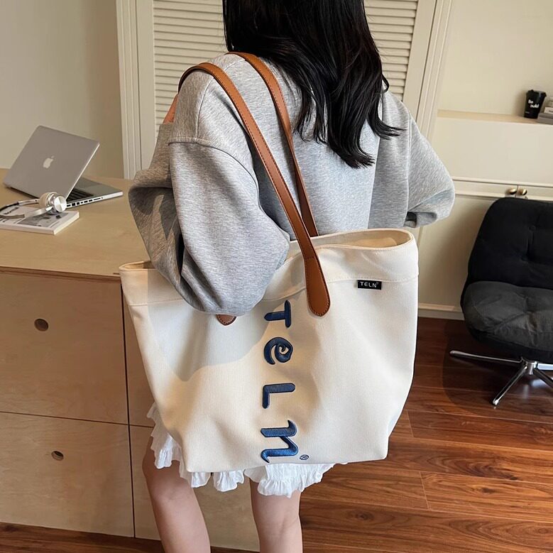 日系小众字母文艺风帆布大包包女2025新款通勤托特包大容量单肩包