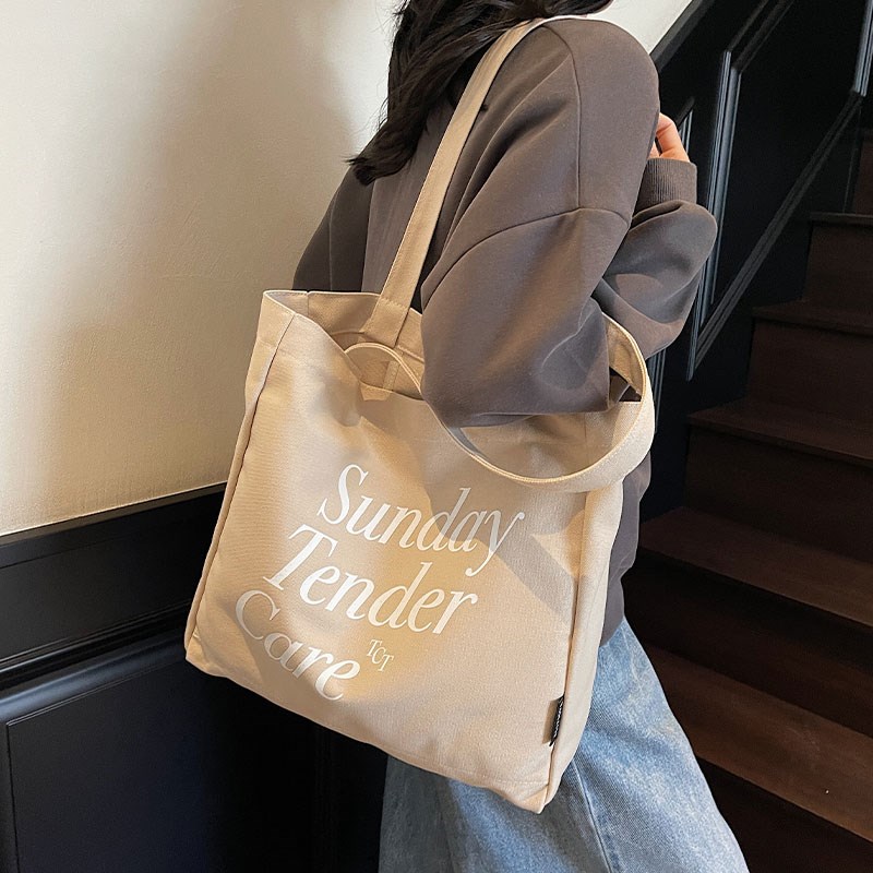 休闲字母帆布包女2025新款大容量单肩通勤包学生上课手提袋托特包