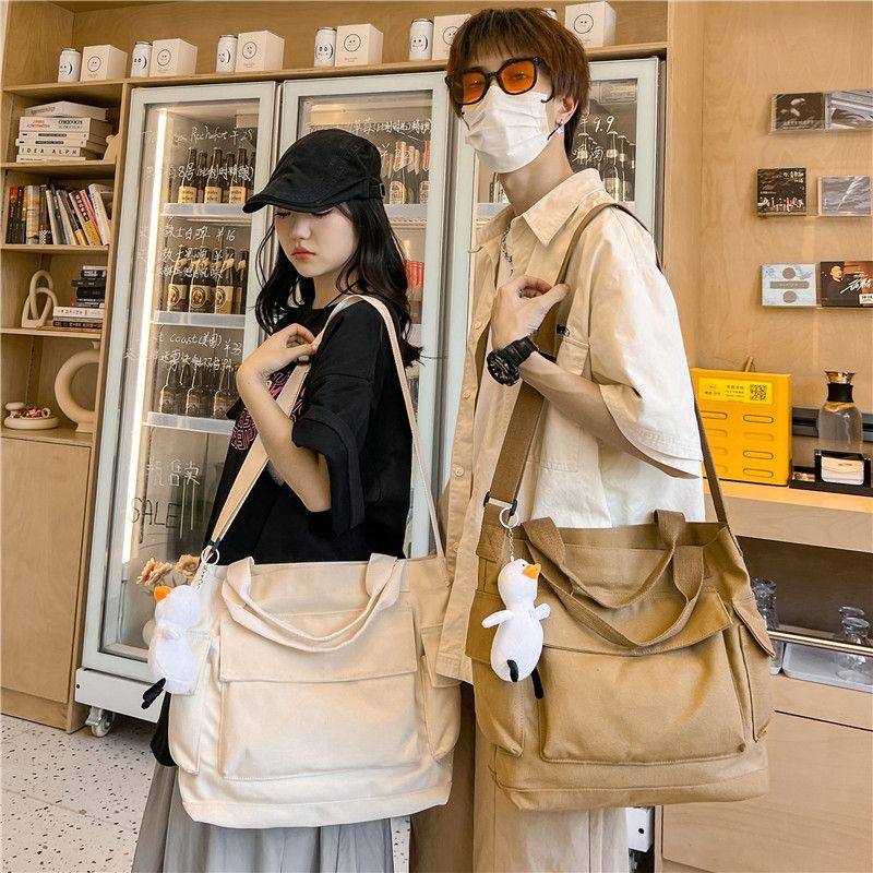 斜挎包男日系水洗复古纯色帆布邮差包大容量学生装书补课手提袋女