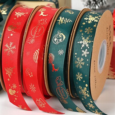 Christmas-themed gold-embossed satin ribbon gift accessory.