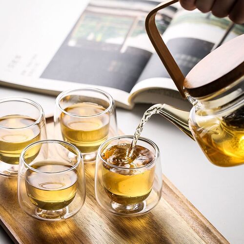 Pyrex tea set with floral tea kettle and wooden holder