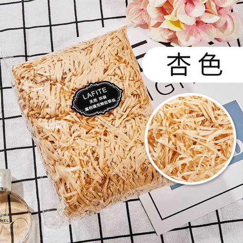 gift lined with shredded paper filling, colored packing box