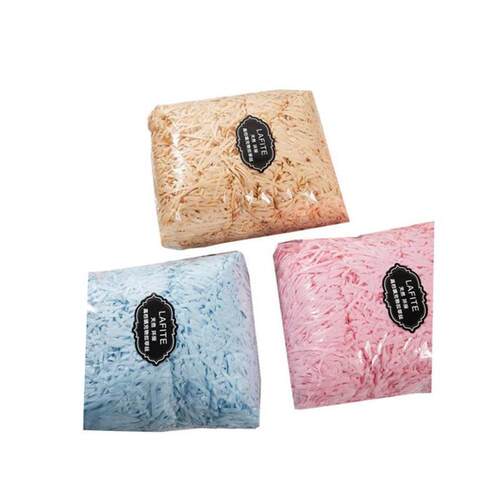 gift lined with shredded paper filling, colored packing box