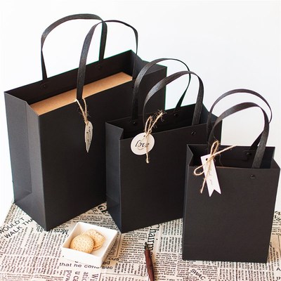 black gift bag, simple paper bag, rivet in hand, gift box,