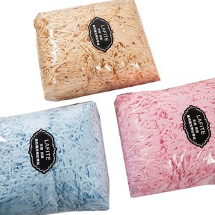 shredded paper filling gift packing with colored box lined