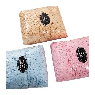 gift lined with shredded paper filling, colored packing box