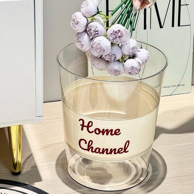A minimalist and transparent acrylic trash bin, perfect as a