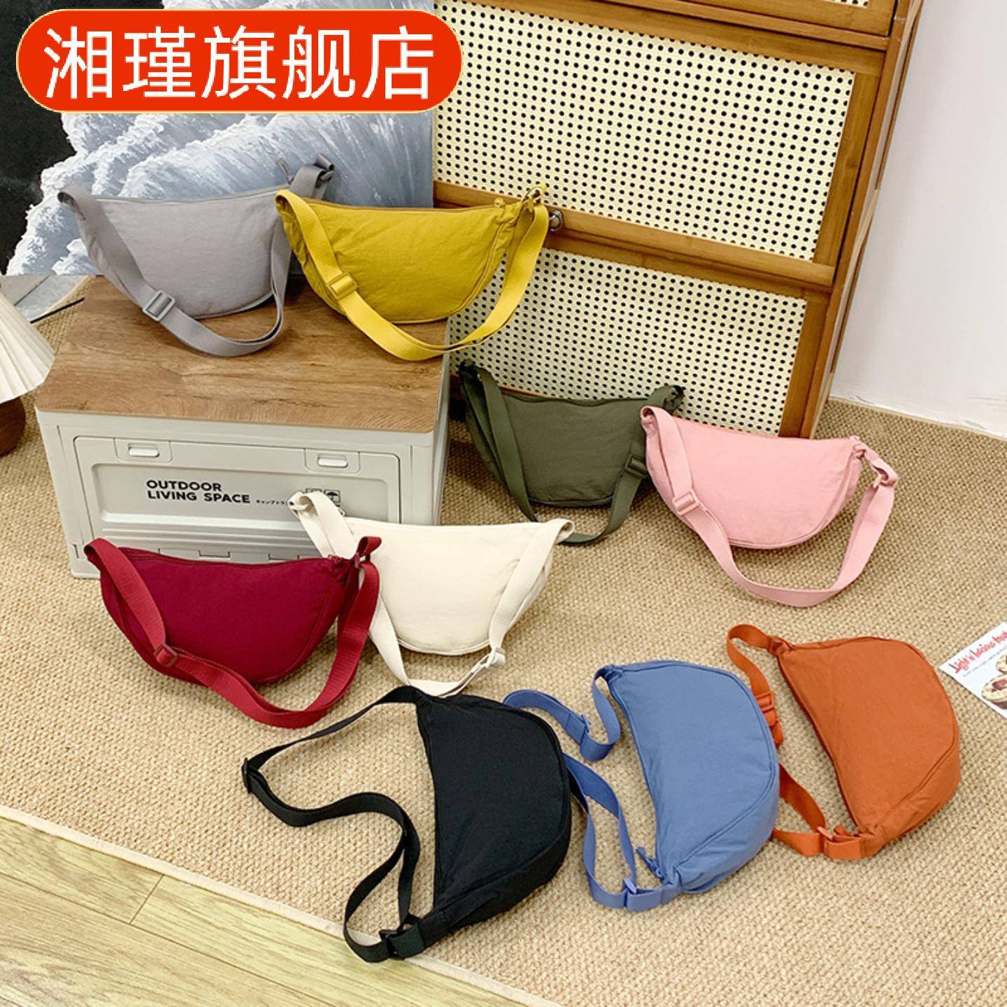 日系纯色手提饺子包女新款斜挎