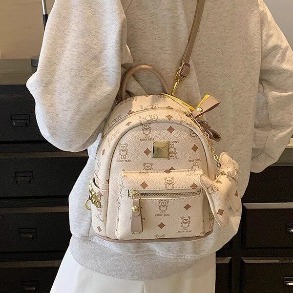 双肩包女包2026新款韩版时尚印花卡通书包大容量铆钉休闲简约背包